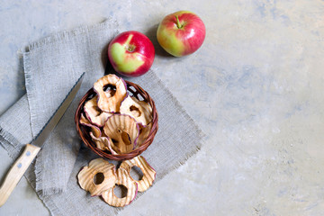 Organic apple chips on a light background. Healthy vegan vegetarian fruit snack. Natural food product