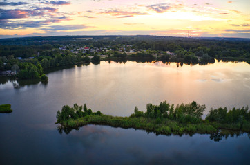 Lake near the forest and the city in the background