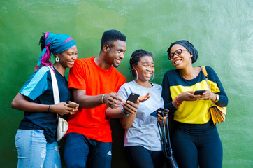 group of young african student feeling excited about the saw on their cellphone