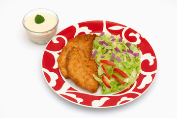 Pechugas de pollo empanizado, con ensalada de verduras.