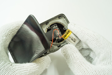 Disassembly car camera to replace new battery on white background, isolated, Car maintenance service.