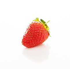 One red strawberrie with a reflection on a white background, close-up