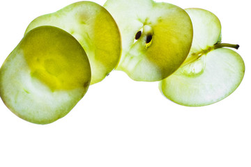 Slices of apple at the backlight isolated on a white background, macro photo