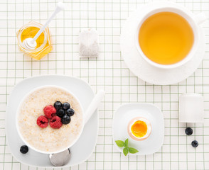 Healthy  Breakfast with oatmeal, boiled egg and herbal tea, lifestyle, top view