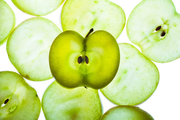 Slices of apple at the backlight isolated on a white background, macro photo