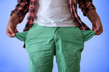 A man in trousers with empty pockets turned out. On a blue and white background.