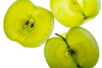 Slices of apple at the backlight isolated on a white background, macro photo