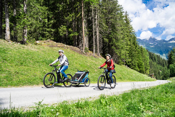 Family With E Bike MTB And Kid Trailer