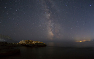 Fototapeta na wymiar Rocky coast near Cape Meganom on a starry night in Crimea