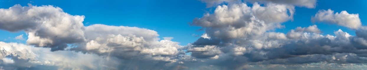 Fantastic clouds against blue sky, panorama