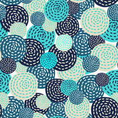 A lot of circles of different sizes of blue, beige, turquoise colors, superimposed on each other. Seamless pattern on a white background.