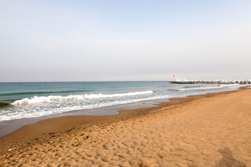 Beach near the sea with sun loungers and parasols