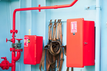 Dry powder fire extinguisher red cabinet on ferry ship