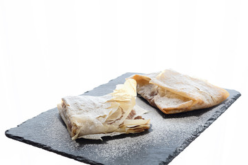 Small desserts of phyllo dough filled with dried fruit. White background and copy space.