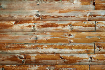 old weathered wooden planks as a brown background, peeling paint and cracks