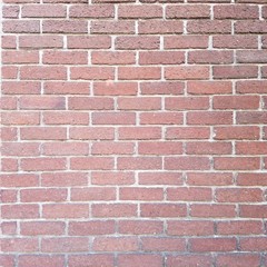 Brightly colored brick wall in busy metropolitan area.