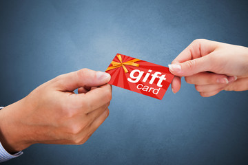 Businesspeople exchanging cards over coffee