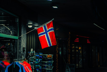 Norwegian flag in the street at night . Norway Flag outside building