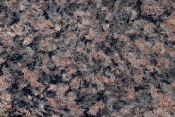 Texture of pink Baltic granite with quartz and mica feldspar granules
