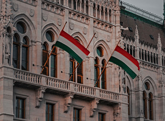 Two Hungarian flags on the parliament building . BUDAPEST, HUNGARY