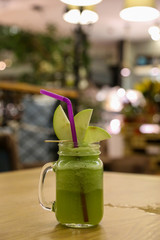 green apple juice close up in a cafe bar