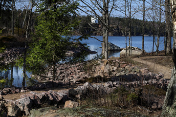 Rocky shores of the Gulf of Finland of the Baltic Sea with small white buildings located on them