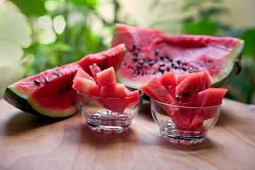 on a wooden table slices of ripe watermelon