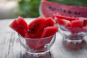 on a wooden table slices of ripe watermelon