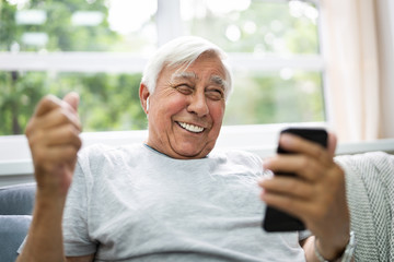 Obraz premium Smiling Older Senior Listening Music