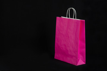 Paper eco bags for shopping in a store on a black background.