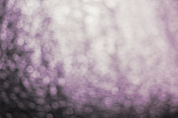 Blurred abstract background of gray, purple, black, white bokeh.