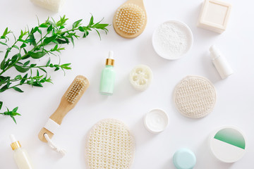 Bath accessories with green plant on white background, top view