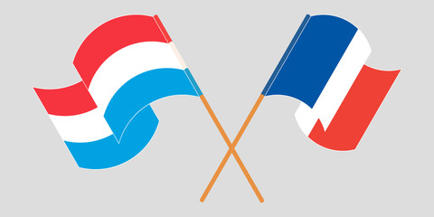 Crossed and waving flags of Luxembourg and France