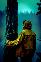 Obraz premium young man and yellow jacket forest rain woods road mystery 