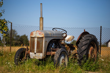 Old tractor standing on the field