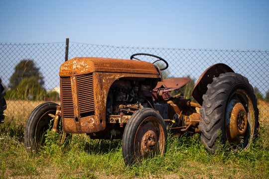 Old tractor standing on the field