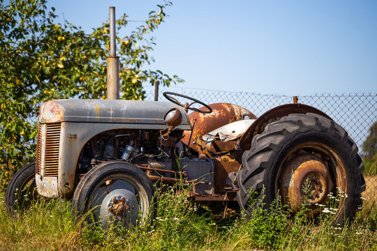 Old tractor standing on the field