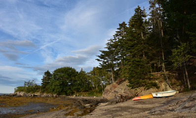 Row Boat and a Kayak on a Deserted Beach
