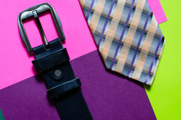 Men's belt and tie on a colorful background. Men's Accessories