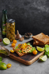 Grilled cheese sandwiches and cherry tomatoes. Cheese and vegetable snacks. Halloumi.