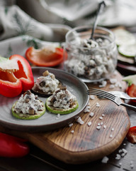 Vegetable snacks with cheese on a wooden cutting board. Vegetarian food.