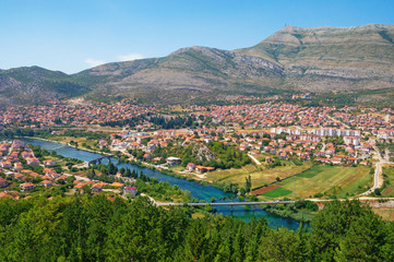 Fototapeta na wymiar Bosnia and Herzegovina, Republika Srpska. View of Trebinje city and Trebisnjica river on sunny summer day