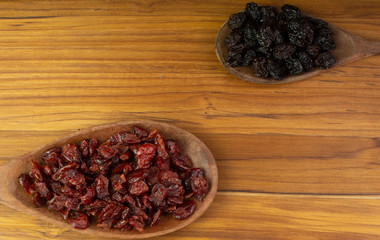 two spoons full of  craberries and almonds