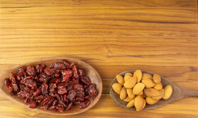 two spoons full of  craberries and almonds