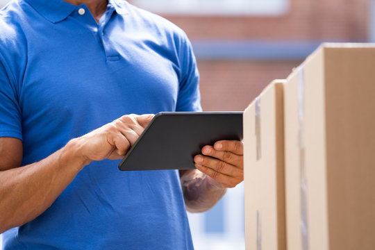 Delivery Man Worker Using Tablet