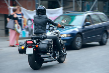 Naklejka premium Stylish girl in black leather clothes driving on motorcycle