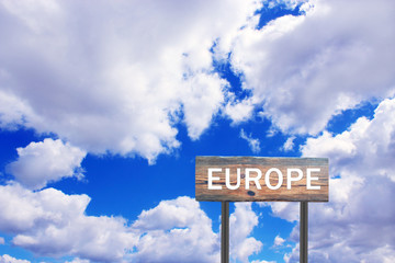 Europe sign on wooden plate. Sign with inscription Europe with view of sky