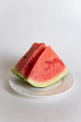 sliced ​​watermelon on a plate isolated on white background