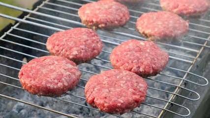 Beef and Pork Patty for Burger. Cooking Cutlets on Mangal. Grill Minced Meat. Chef Cooks burger in street outdoors. Summer Picnic in Nature. Tasty Meat Dish. Closeup