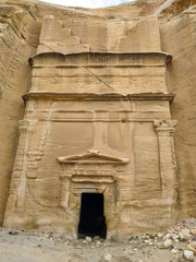 Step tomb in ancient Petra city in Jordan. The building is carved out of sandstone right into the rock. Theme of travel in Jordan.